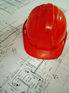 Hard hat on building plan - leaky buildings