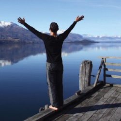 Man standing on lakeside jetty
