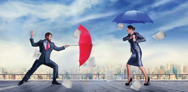 Office conflict - a man and a woman fencing with umbrellas 